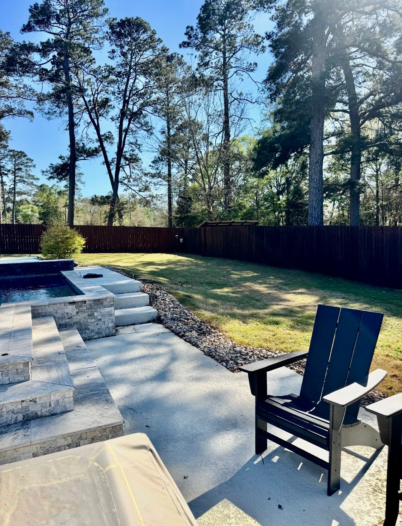 Finished wood privacy fence around a backyard pool in Shreveport, Louisiana